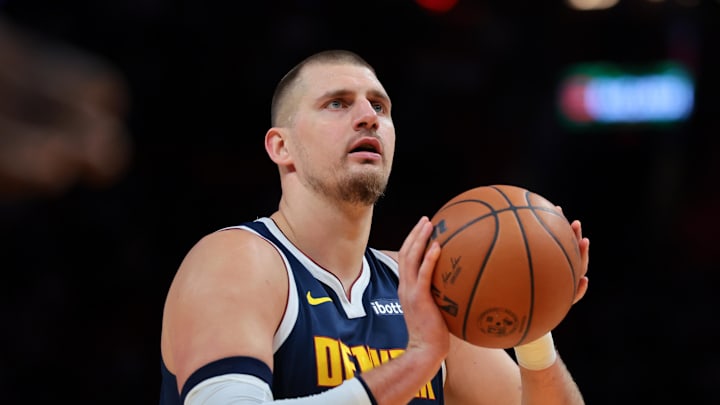 Dec 29, 2025; Miami, Florida, USA; Denver Nuggets center Nikola Jokic (15) shoots a free throw against the Miami Heat during the first quarter at Kaseya Center.