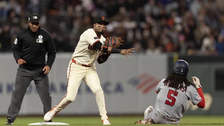 San Francisco Giants second baseman Luis Arraez (1) throws over Washington Nationals shortstop CJ Abrams (5) to complete a double play during the seventh inning at Oracle Park. San Francisco Giants second baseman Luis Arraez (1) throws over Washington Nationals shortstop CJ Abrams (5) to complete a double play during the seventh inning at Oracle Park.