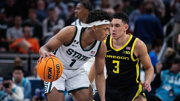 Mar 14, 2025; Indianapolis, IN, USA;  Michigan State Spartans guard Jeremy Fears Jr. (1) dribbles the ball while Oregon Ducks guard Jackson Shelstad (3) defends in the second half  at Gainbridge Fieldhouse. Mandatory Credit: Trevor Ruszkowski-Imagn Images