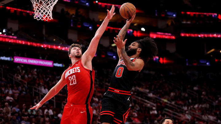 Chicago Bulls guard Coby White (0) drives to the basket against Houston Rockets center Alperen Sengun (28) during the second quarter at Toyota Center.