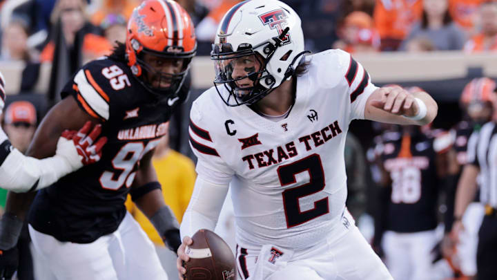 Texas Tech's Behren Morton (2) runs the ball away from Oklahoma State's Jaleel Johnson 