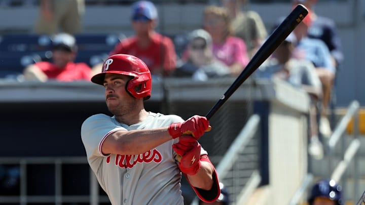 Feb 25, 2025; Port Charlotte, Florida, USA;  Philadelphia Phillies infielder Otto Kemp (82) hits a RBI double against the Tampa Bay Rays during the fourth inning at Charlotte Sports Park.