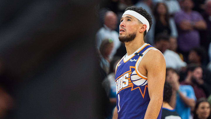 Nov 10, 2024; Phoenix, Arizona, USA; Phoenix Suns guard Devin Booker (1) reacts to the scoreboard during a time-out in the second half during a game against the Sacramento Kings at Footprint Center. Mandatory Credit: Allan Henry-Imagn Images