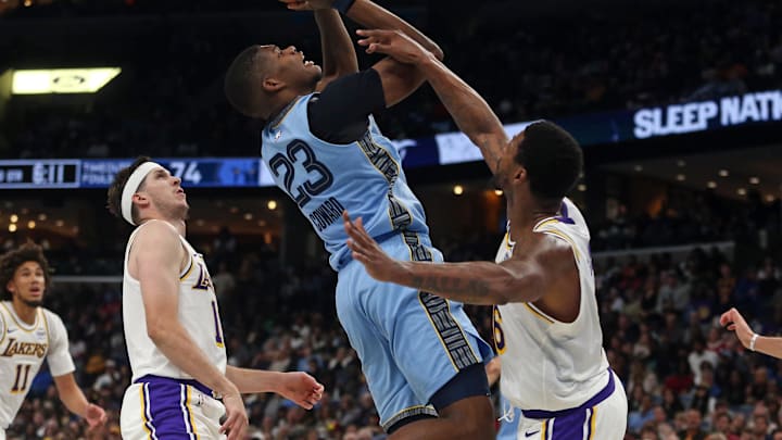 Oct 31, 2025; Memphis, Tennessee, USA; Memphis Grizzlies forward Cedric Coward (23) shoots as Los Angeles Lakers guard Marcus Smart (36) defends during the third quarter at FedExForum. Mandatory Credit: Petre Thomas-Imagn Images
