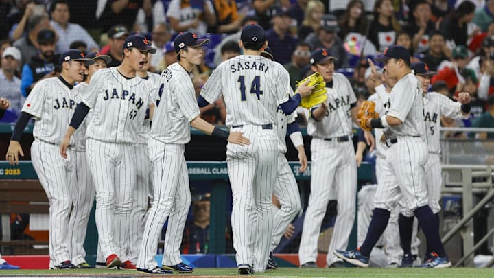 Mar 20, 2023; Miami, Florida, USA; Japan starting pitcher Roki Sasaki (14) celebrates with teammates after the first inning against Mexico at LoanDepot Park.