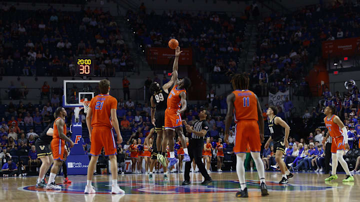 Feb 4, 2025; Gainesville, Florida, USA; Florida Gators center Rueben Chinyelu (9) and Vanderbilt Commodores forward Devin McGlockton (99) tip off at Exactech Arena at the Stephen C. O'Connell Center. Mandatory Credit: Morgan Tencza-Imagn Images