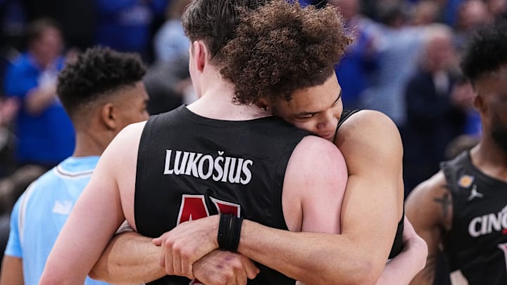 Cincinnati Bearcats guard Dan Skillings Jr. (0) hugs Cincinnati Bearcats guard Simas Lukosius (41) on Tuesday, March 26, 2024, after the quarterfinals of the NIT at the Hulman Center in Terre Haute. The Indiana State Sycamores defeated the Cincinnati Bearcats, 85-81.