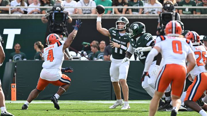Oct 10, 2026; East Lansing, Michigan, USA; Michigan State Spartans quarterback Alessio Milivojevic (11) throws to Michigan State Spartans tight end Jayden Savoury (31) over the hands of Illinois Fighting Illini linebacker Daniel Brown (4) during the first quarter at Spartan Stadium. Mandatory Credit: Dale Young-Imagn Images Oct 10, 2026; East Lansing, Michigan, USA; Michigan State Spartans quarterback Alessio Milivojevic (11) throws to Michigan State Spartans tight end Jayden Savoury (31) over the hands of Illinois Fighting Illini linebacker Daniel Brown (4) during the first quarter at Spartan Stadium. Mandatory Credit: Dale Young-Imagn Images