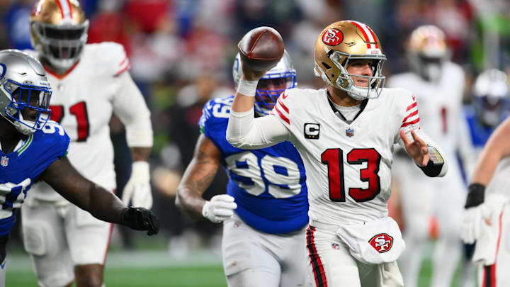 Oct 10, 2024; Seattle, Washington, USA; San Francisco 49ers quarterback Brock Purdy (13) passes the ball against the Seattle Seahawks during the second half at Lumen Field. Mandatory Credit: Steven Bisig-Imagn Images