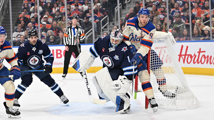 Dec 6, 2025; Edmonton, Alberta, CAN; Edmonton Oilers center Connor McDavid (97) and Winnipeg Jets goalie Eric Comrie (1) collide during the first period at Rogers Place. Mandatory Credit: Walter Tychnowicz-Imagn Images Dec 6, 2025; Edmonton, Alberta, CAN; Edmonton Oilers center Connor McDavid (97) and Winnipeg Jets goalie Eric Comrie (1) collide during the first period at Rogers Place. Mandatory Credit: Walter Tychnowicz-Imagn Images