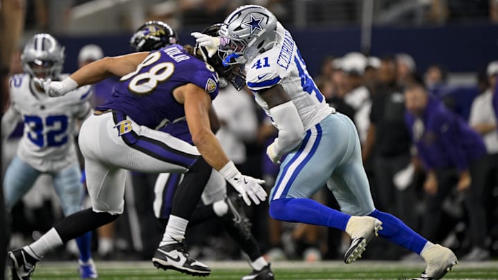 Baltimore Ravens tight end Charlie Kolar and Dallas Cowboys defensive end Donovan Ezeiruaku in action.