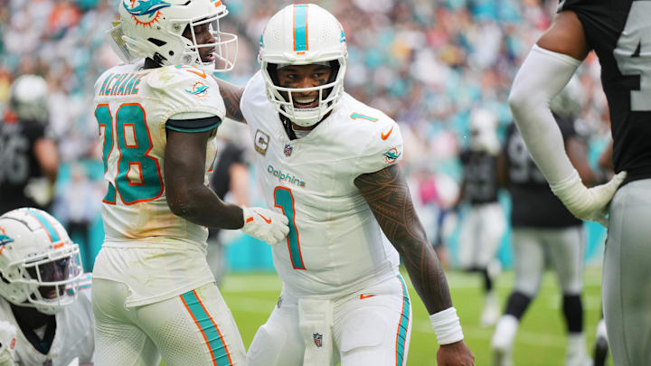 Miami Dolphins quarterback Tua Tagovailoa (1) celebrates a touchdown by running back De'Von Achane (28) against the Las Vegas Raiders in the fourth quarter at Hard Rock Stadium. 