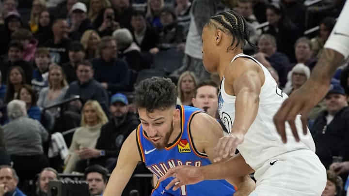 Feb 13, 2025; Minneapolis, Minnesota, USA; Oklahoma City Thunder center Chet Holmgren (7) dribbles around Minnesota Timberwolves guard Jaylen Clark (22) in the first quarter at Target Center. Mandatory Credit: Bruce Kluckhohn-Imagn Images