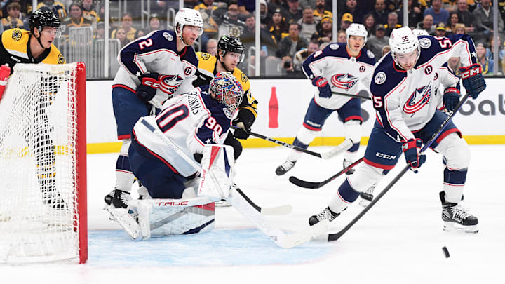 Nov 18, 2024; Boston, Massachusetts, USA;  Columbus Blue Jackets defenseman David Jiricek (55) looks for a rebound in front of goaltender Elvis Merzlikins (90) during the first period against the Boston Bruins at TD Garden. Mandatory Credit: Bob DeChiara-Imagn Images