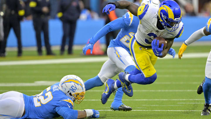 Jan 1, 2023; Inglewood, California, USA; Los Angeles Rams running back Cam Akers (3) breaks away from Los Angeles Chargers linebacker Khalil Mack (52) for a first down in the second half at SoFi Stadium. Mandatory Credit: Jayne Kamin-Oncea-Imagn Images