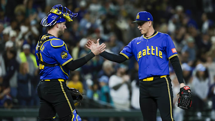 Sep 25, 2025; Seattle, Washington, USA; Seattle Mariners catcher Mitch Garver (18) shakes hands with pitcher Casey Legumina (64) following a victory against the Colorado Rockies inning at T-Mobile Park. Mandatory Credit: Joe Nicholson-Imagn Images