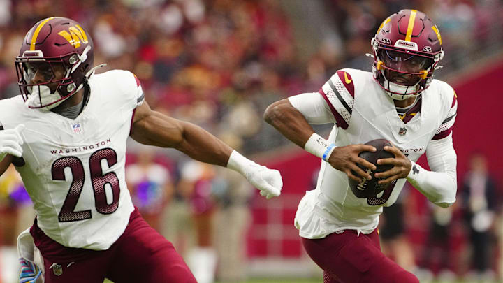 Commanders quarterback Jayden Daniels (5) scrambles out of the pocket against the Cardinals during a game at State Farm Stadium in Glendale, on Ariz. Sept 29, 2024.
