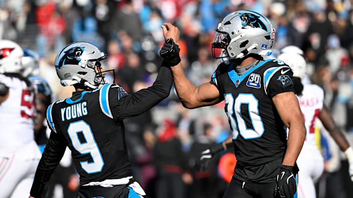 Dec 22, 2024; Charlotte, North Carolina, USA;  Carolina Panthers running back Chuba Hubbard (30) celebrates with quarterback Bryce Young (9) after scoring a touchdown in the first quarter at Bank of America Stadium. Mandatory Credit: Bob Donnan-Imagn Images