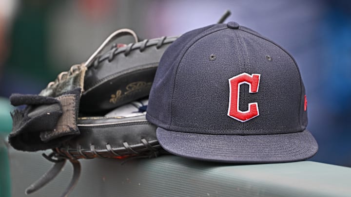 Jun 27, 2024; Kansas City, Missouri, USA; A general view a Cleveland Guardians hat and glove on the dugout railing before a game against the Kansas City Royals at Kauffman Stadium. Mandatory Credit: Peter Aiken-Imagn Images Jun 27, 2024; Kansas City, Missouri, USA; A general view a Cleveland Guardians hat and glove on the dugout railing before a game against the Kansas City Royals at Kauffman Stadium. Mandatory Credit: Peter Aiken-Imagn Images