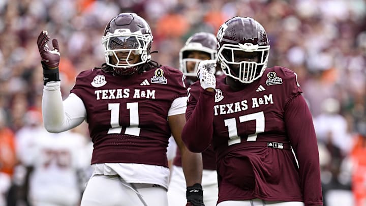 Dec 20, 2025; College Station, TX, USA; Texas A&M Aggies defensive tackle Albert Regis (17) and defensive tackle Tyler Onyedim (11) celebrate during the game between the Aggies and the Hurricanes at Kyle Field. Mandatory Credit: Jerome Miron-Imagn Images