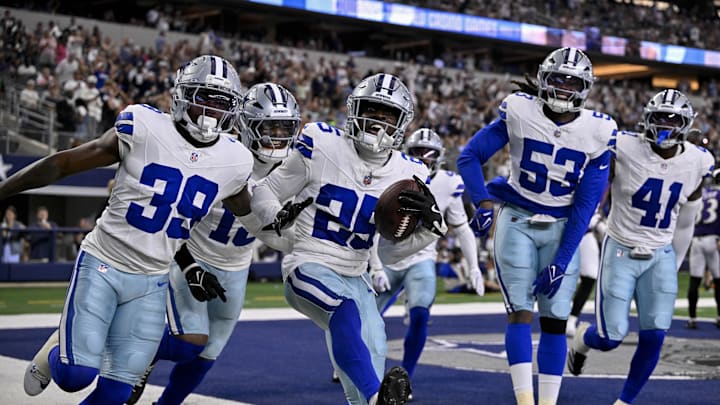 Dallas Cowboys defenders Andrew Booth, Mike Smith Jr. and James Houston celebrate after Booth returns an interception for a touchdown Dallas Cowboys defenders Andrew Booth, Mike Smith Jr. and James Houston celebrate after Booth returns an interception for a touchdown