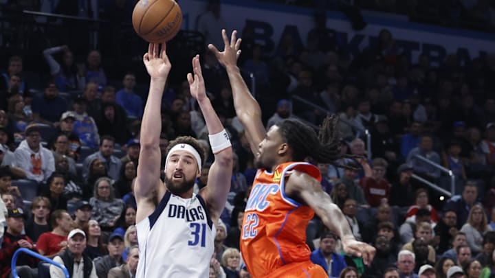 Dec 10, 2024; Oklahoma City, Oklahoma, USA; Dallas Mavericks guard Klay Thompson (31) shoots as Oklahoma City Thunder guard Cason Wallace (22) defends during the second half at Paycom Center. Mandatory Credit: Alonzo Adams-Imagn Images
