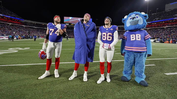 Buffalo Bills offensive tackle Ryan van Demark, right tackle Spencer Brown, tight end Dalton Kincaid and Billy Buffalo watch the video playing on the jumbo screens showing the Bills over the years playing at Highmark Stadium in Orchard Park on Jan. 4, 2026. Buffalo Bills offensive tackle Ryan van Demark, right tackle Spencer Brown, tight end Dalton Kincaid and Billy Buffalo watch the video playing on the jumbo screens showing the Bills over the years playing at Highmark Stadium in Orchard Park on Jan. 4, 2026.