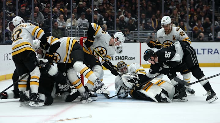 Nov 21, 2025; Los Angeles, California, USA;  Los Angeles Kings defenseman Brandt Clarke (92) attempts to score against Boston Bruins goaltender Jeremy Swayman (1) during the second period at Crypto.com Arena. Mandatory Credit: Kiyoshi Mio-Imagn Images