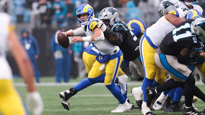 Nov 30, 2025; Charlotte, North Carolina, USA; Los Angeles Rams quarterback Matthew Stafford (9) is sacked by Carolina Panthers defensive end Derrick Brown (95) during the fourth quarter at Bank of America Stadium. Mandatory Credit: Scott Kinser-Imagn Images
