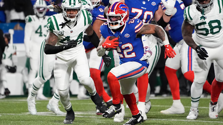 Jan 4, 2026; Orchard Park, New York, USA; Buffalo Bills running back Ray Davis (22) carries the ball defended by New York Jets linebacker Jamien Sherwood (44) during the second half at Highmark Stadium. 
