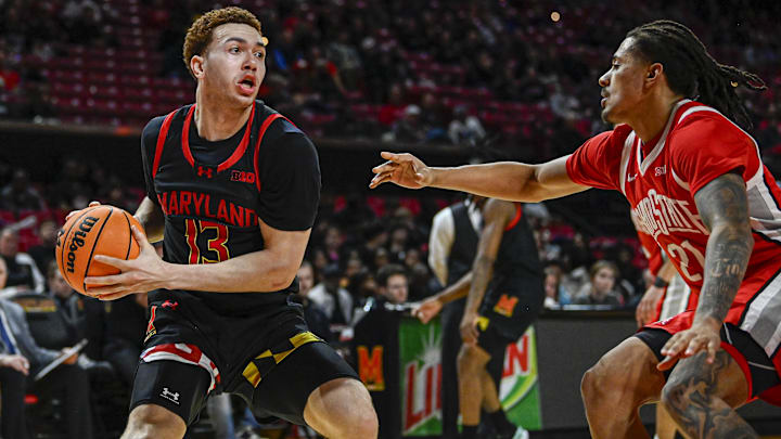 Feb 5, 2026; College Park, Maryland, USA;  Maryland Terrapins forward Elijah Saunders (13) looks to pass as Ohio State Buckeyes forward Devin Royal (21) defends during the second half at Xfinity Center. Mandatory Credit: Tommy Gilligan-Imagn Images
