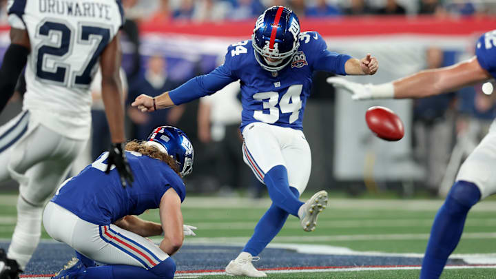 Sep 26, 2024; East Rutherford, New Jersey, USA; New York Giants place kicker Greg Joseph (34) kicks a field goal with punter Jamie Gillan (6) holding during the first quarter against the Dallas Cowboys at MetLife Stadium.  