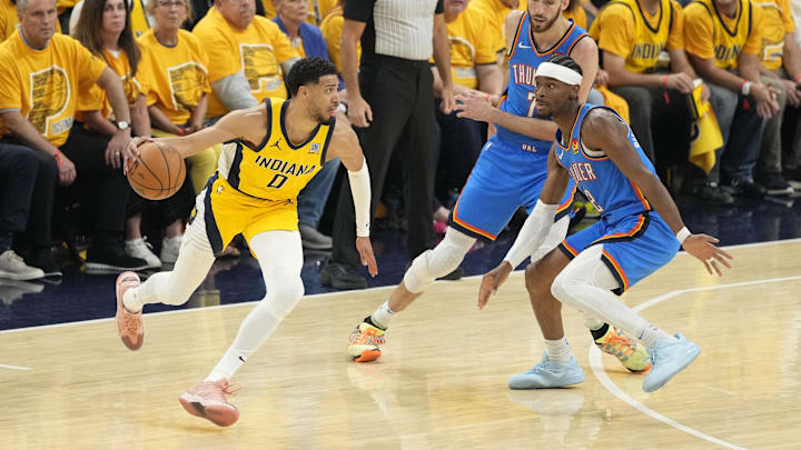 Jun 13, 2025; Indianapolis, Indiana, USA; Indiana Pacers guard Tyrese Haliburton dribbles the ball against Oklahoma City Thunder forward Chet Holmgren and guard Shai Gilgeous-Alexander / Kyle Terada-Imagn Images