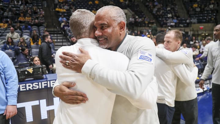 Jan 27, 2026; Morgantown, West Virginia, USA; Kansas State Wildcats head coach Jerome Tang talks with West Virginia Mountaineers head coach Ross Hodge before the game at Hope Coliseum. Mandatory Credit: Ben Queen-Imagn Imagesa