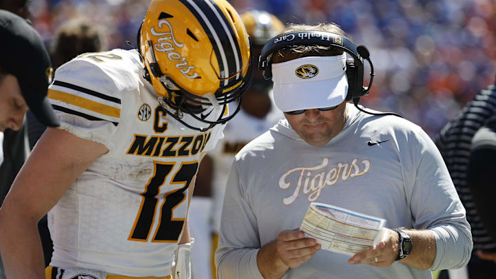 Oct 8, 2022; Gainesville, Florida, USA; Missouri Tigers head coach Eliah Drinkwitz and quarterback Brady Cook (12) talk against the Florida Gators during the second half at Ben Hill Griffin Stadium. Mandatory Credit: Kim Klement-Imagn Images