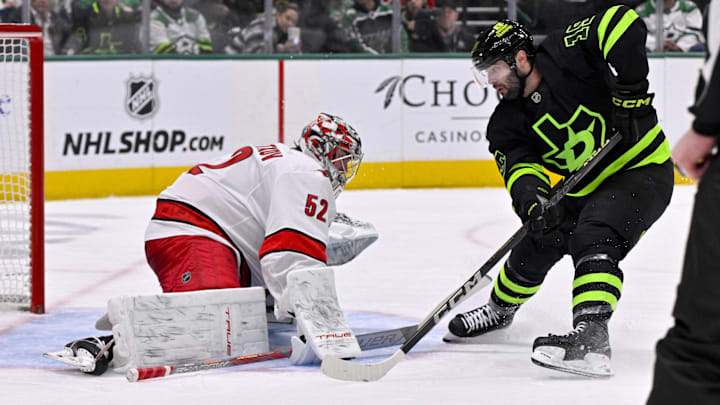 Jan 21, 2025; Dallas, Texas, USA; Carolina Hurricanes goaltender Pyotr Kochetkov (52) stops a shot by Dallas Stars center Colin Blackwell (15) during the second period at the American Airlines Center. Mandatory Credit: Jerome Miron-Imagn Images