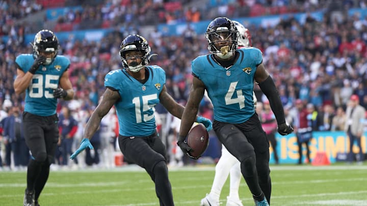 Oct 20, 2024; London, United Kingdom; Jacksonville Jaguars running back Tank Bigsby (4) celebrates a touchdown with teammates Jacksonville Jaguars wide receiver Tim Jones (15) and Jacksonville Jaguars tight end Brenton Strange (85) in the second half during an NFL International Series game at Wembley Stadium.