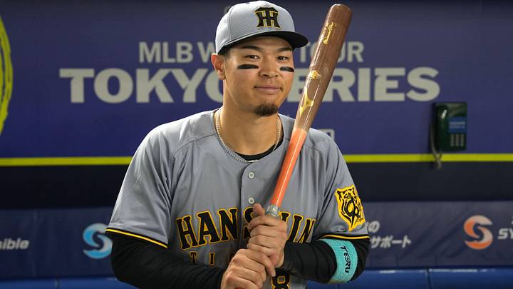 Mar 15, 2025; Bunkyo, Tokyo, Japan; Hanshin Tigers right fielder Teruaki Sato (8) poses for a photo after defeating the Chicago Cubs at Tokyo Dome. Mandatory Credit: Darren Yamashita-Imagn Images Mar 15, 2025; Bunkyo, Tokyo, Japan; Hanshin Tigers right fielder Teruaki Sato (8) poses for a photo after defeating the Chicago Cubs at Tokyo Dome. Mandatory Credit: Darren Yamashita-Imagn Images
