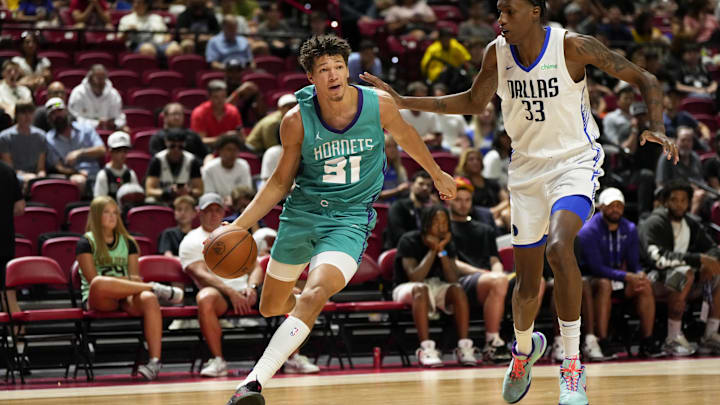 Jul 14, 2025; Las Vegas, NV, USA; Charlotte Hornets forward Tidjane Salaun (31) dribbles the ball against Dallas Mavericks center Jamarion Sharp (33) during the second half of a NBA basketball game at the Thomas & Mack Center. Mandatory Credit: Lucas Peltier-Imagn Images