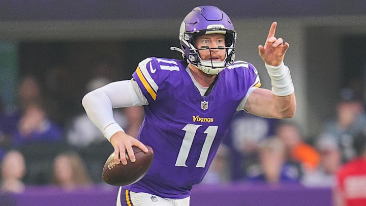 Minnesota Vikings quarterback Carson Wentz (11) scrambles against the Cincinnati Bengals during the first half at U.S. Bank Stadium.