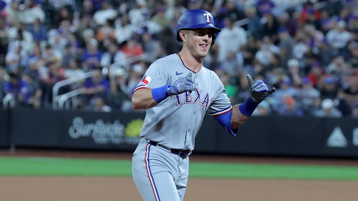 Sep 12, 2025; New York City, New York, USA; Texas Rangers second baseman Dylan Moore (25) reacts as he rounds the bases after hitting a two run home run against the New York Mets during the seventh inning at Citi Field. Mandatory Credit: Brad Penner-Imagn Images