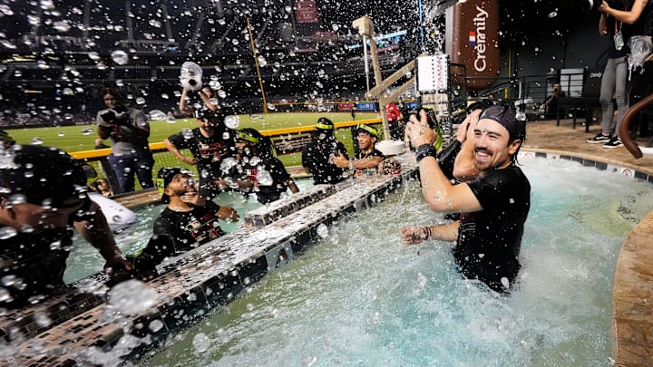 Arizona Diamondbacks Corbin Carroll splashes his teammates in the outfield pool during post-game celebrations after clinching a wild card playoff spot following their game with the Houston Astros at Chase Field on Sept 30, 2023.