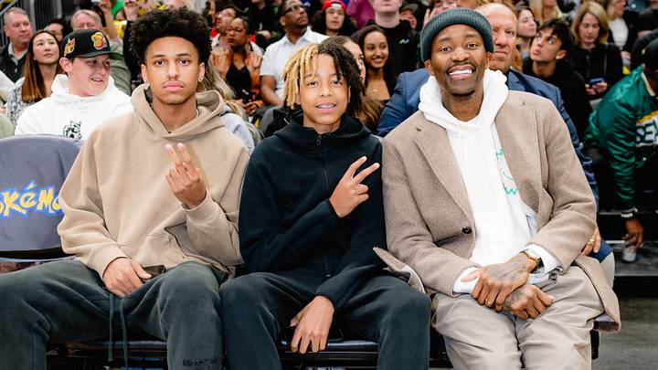 A young JJ Crawford, center, takes in an NBA game with his dad, Jamal. A young JJ Crawford, center, takes in an NBA game with his dad, Jamal.