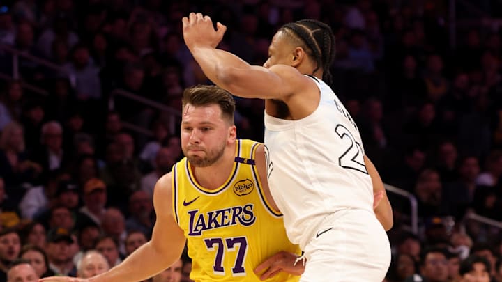 Feb 27, 2025; Los Angeles, California, USA; Los Angeles Lakers guard Luka Doncic (77) drives against Minnesota Timberwolves guard Jaylen Clark (22) during the first quarter at Crypto.com Arena. Mandatory Credit: Jason Parkhurst-Imagn Images