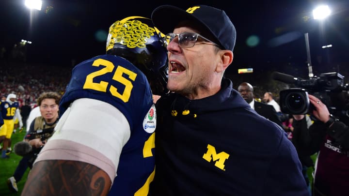 Jan 1, 2024; Pasadena, CA, USA; Michigan Wolverines head coach Jim Harbaugh celebrates with linebacker Junior Colson (25) after defeating the Alabama Crimson Tide in the 2024 Rose Bowl college football playoff semifinal game at Rose Bowl. Mandatory Credit: Gary A. Vasquez-USA TODAY Sports