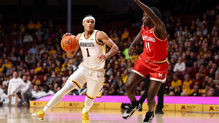 Feb 8, 2026; Minneapolis, Minnesota, USA; Minnesota Golden Gophers guard Isaac Asuma (1) works around Maryland Terrapins guard George Turkson Jr. (11) during the first half at Williams Arena.