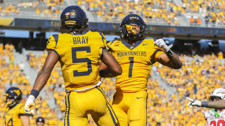 Aug 30, 2025; Morgantown, West Virginia, USA; West Virginia Mountaineers running back Jahiem White (1) scores a touchdown and celebrates with West Virginia Mountaineers wide receiver Jaden Bray (5) during the third quarter at Milan Puskar Stadium. Mandatory Credit: Ben Queen-Imagn Images