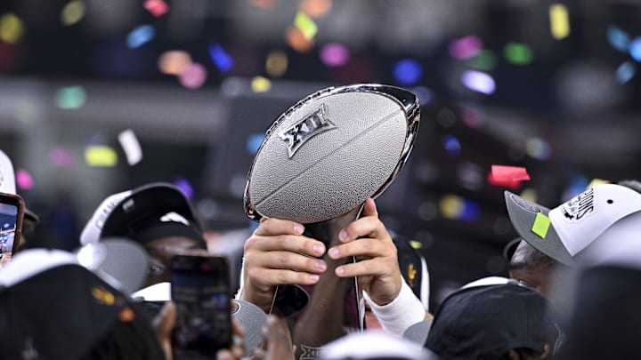 Dec 7, 2024; Arlington, TX, USA; The Arizona State Sun Devils team celebrate with the trophy after the Sun Devils defeat the Iowa State Cyclones and win the 2024 Big 12 Championship at AT&T Stadium. Mandatory Credit: Jerome Miron-Imagn Images