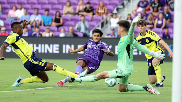 May 21, 2025; Orlando, Florida, USA; Orlando City forward Ramiro Enrique (7) shoots against Nashville SC goalkeeper Brian Schwake (99) during the first half at Inter&Co Stadium. Mandatory Credit: Kim Klement Neitzel-Imagn Images