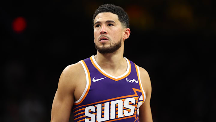 Dec 18, 2025; Phoenix, Arizona, USA; Phoenix Suns guard Devin Booker (1) against the Golden State Warriors at Mortgage Matchup Center. Mandatory Credit: Mark J. Rebilas-Imagn Images